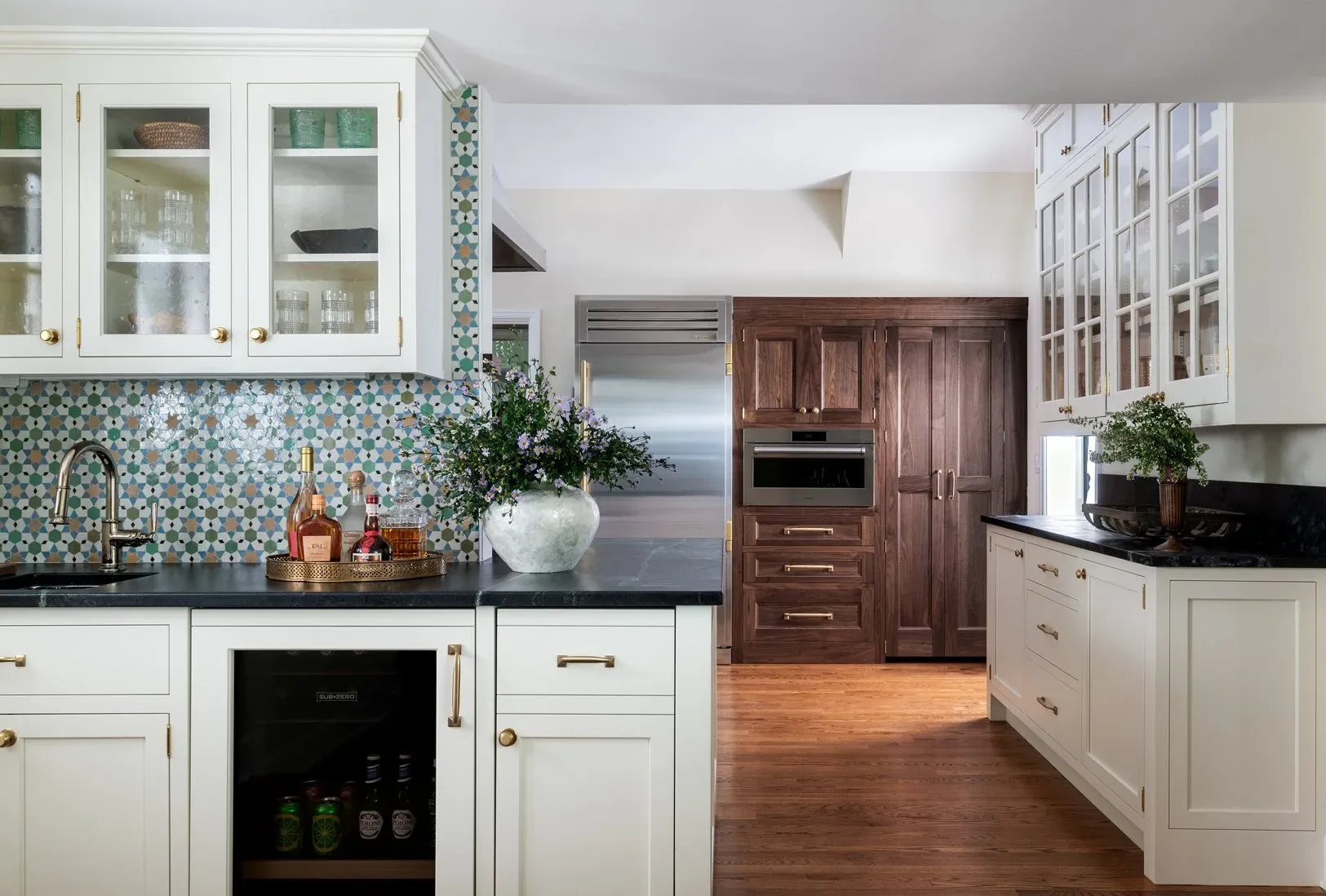 Kitchen interior design featuring white cabinetry and decorative tile backsplash