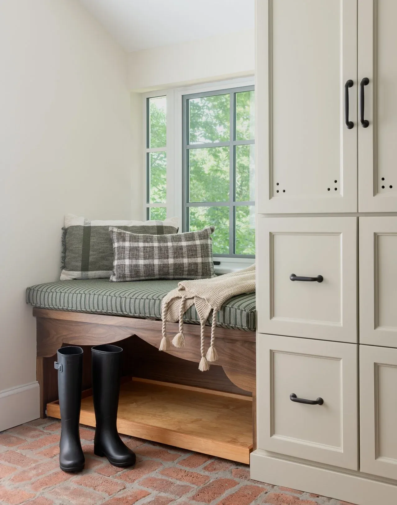 Elegant mudroom with custom cabinetry and warm finishes