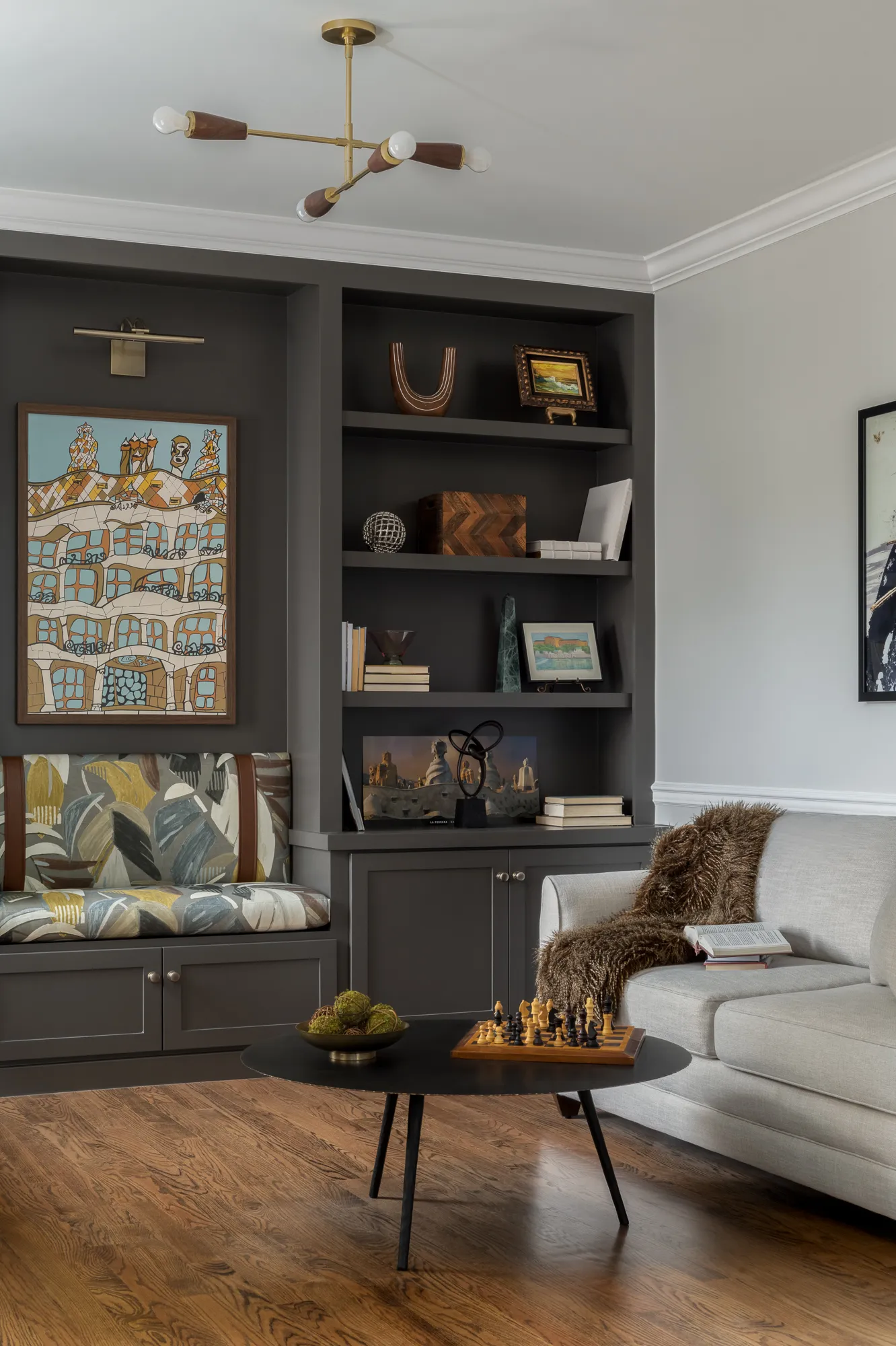 Living room shelving wall with leather chair and cream sofa