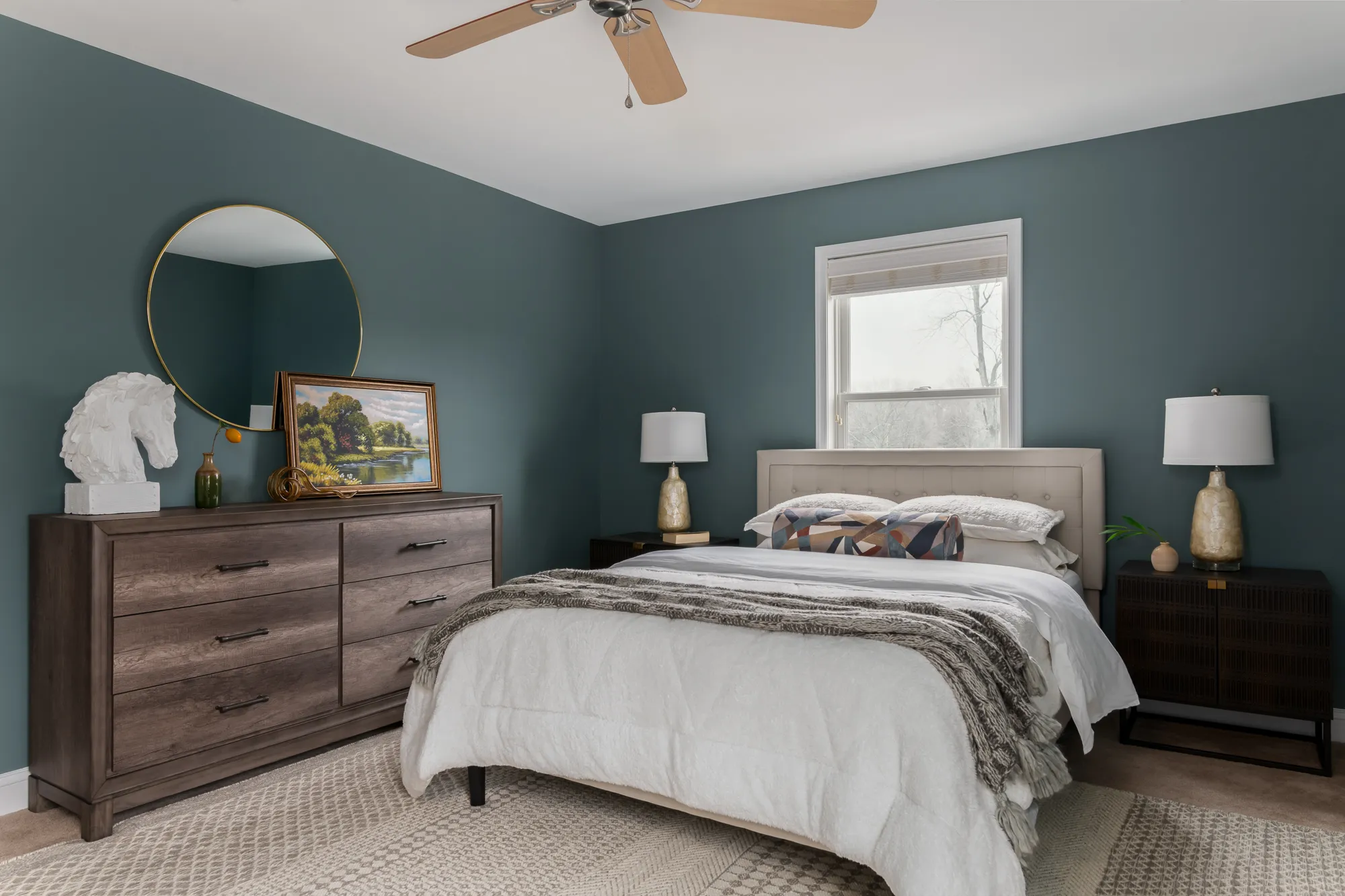 Guest bedroom featuring rich teal walls and leather headboard