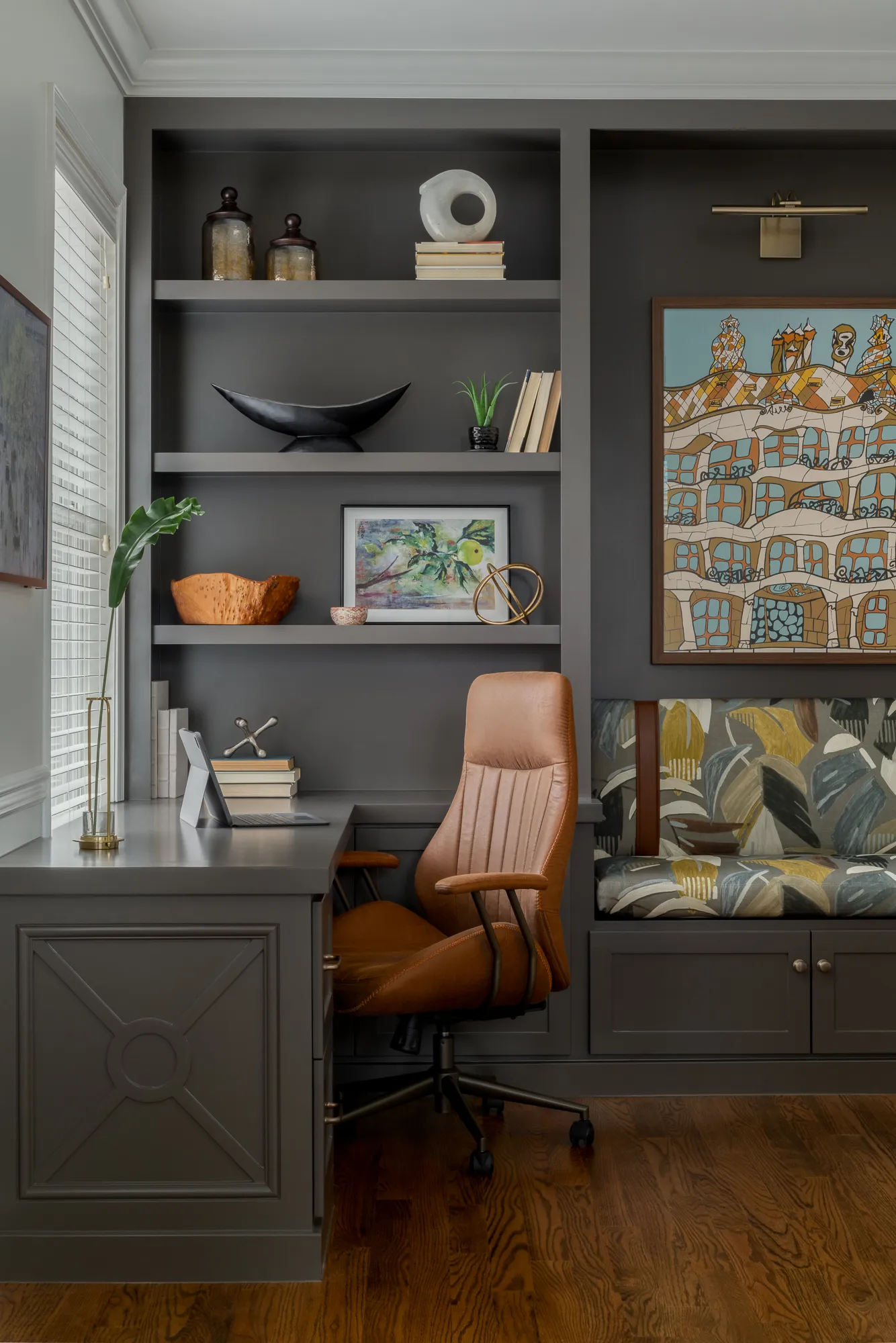 Built-in desk nook with leather chair and curated shelving
