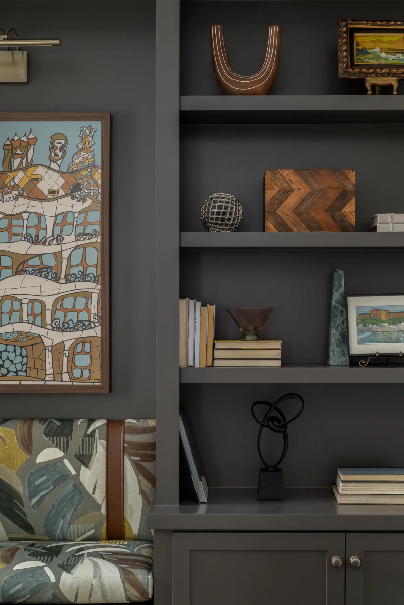 Shelf detail with sculptural objects and vintage books