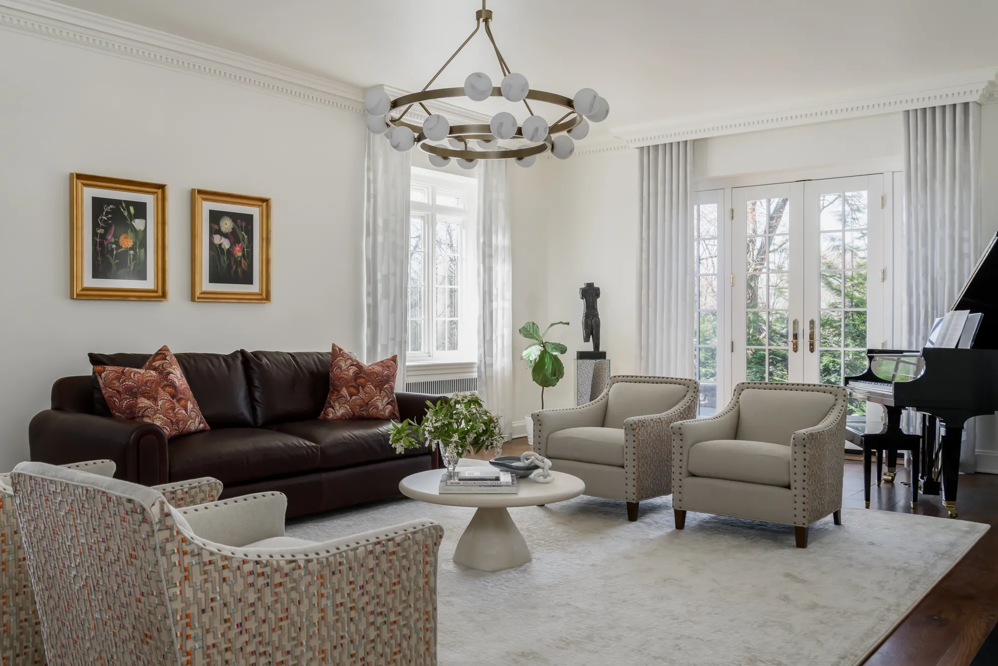 Light-filled living room with leather sofa, upholstered chairs, and grand piano designed by Lennon Nora Interior Design