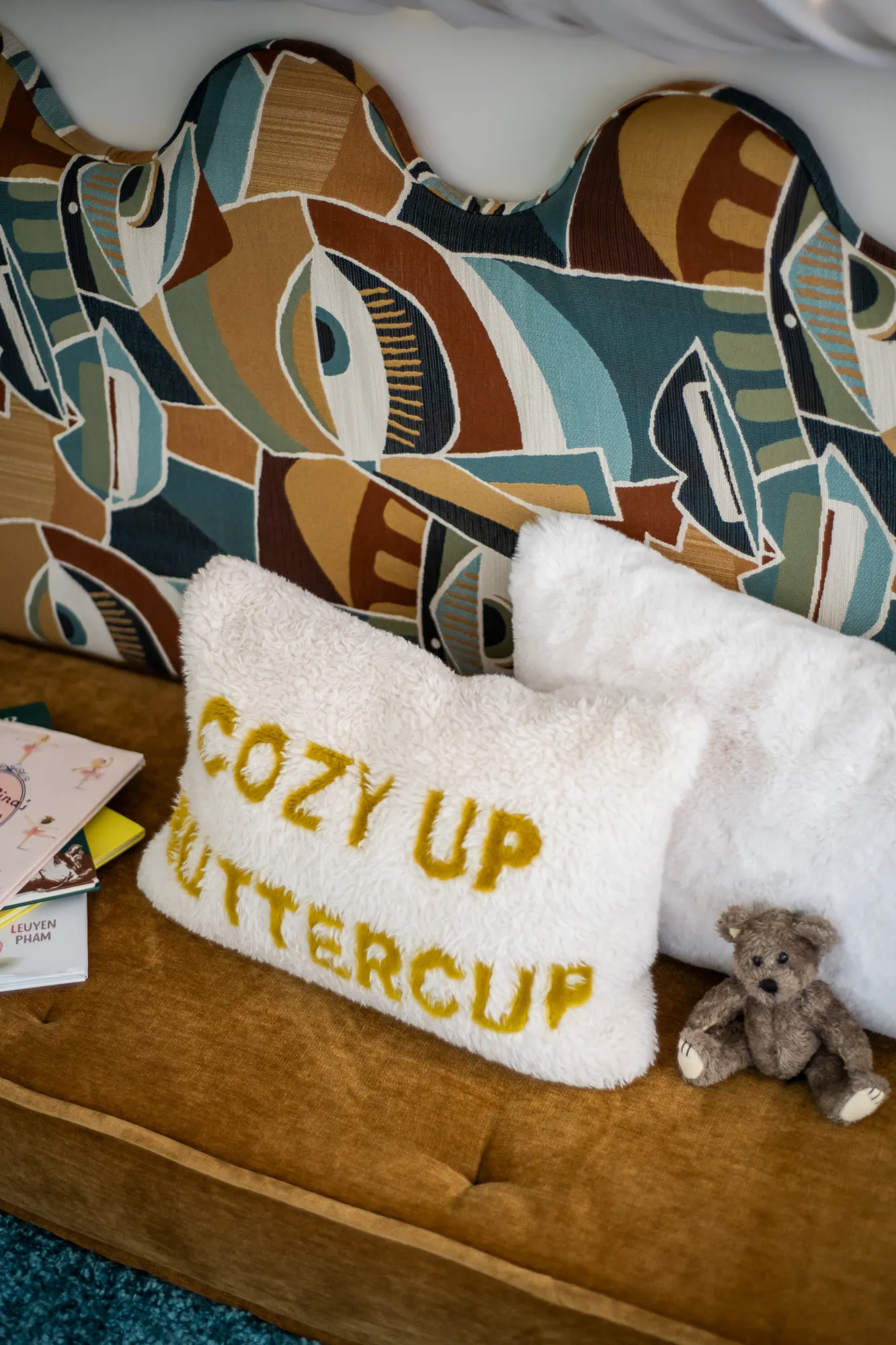 Reading nook pillow detail with cozy textures and patterned upholstery