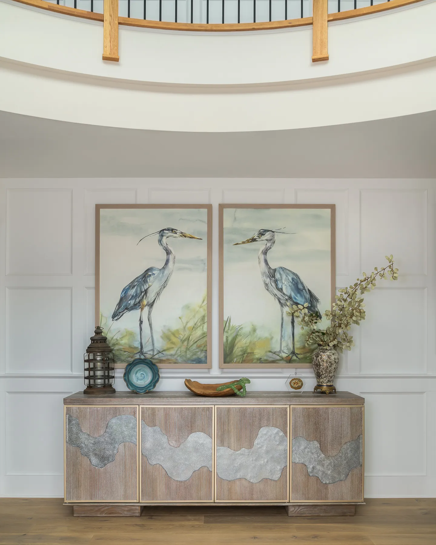 Blue heron paintings over driftwood console with agate and sea glass accents