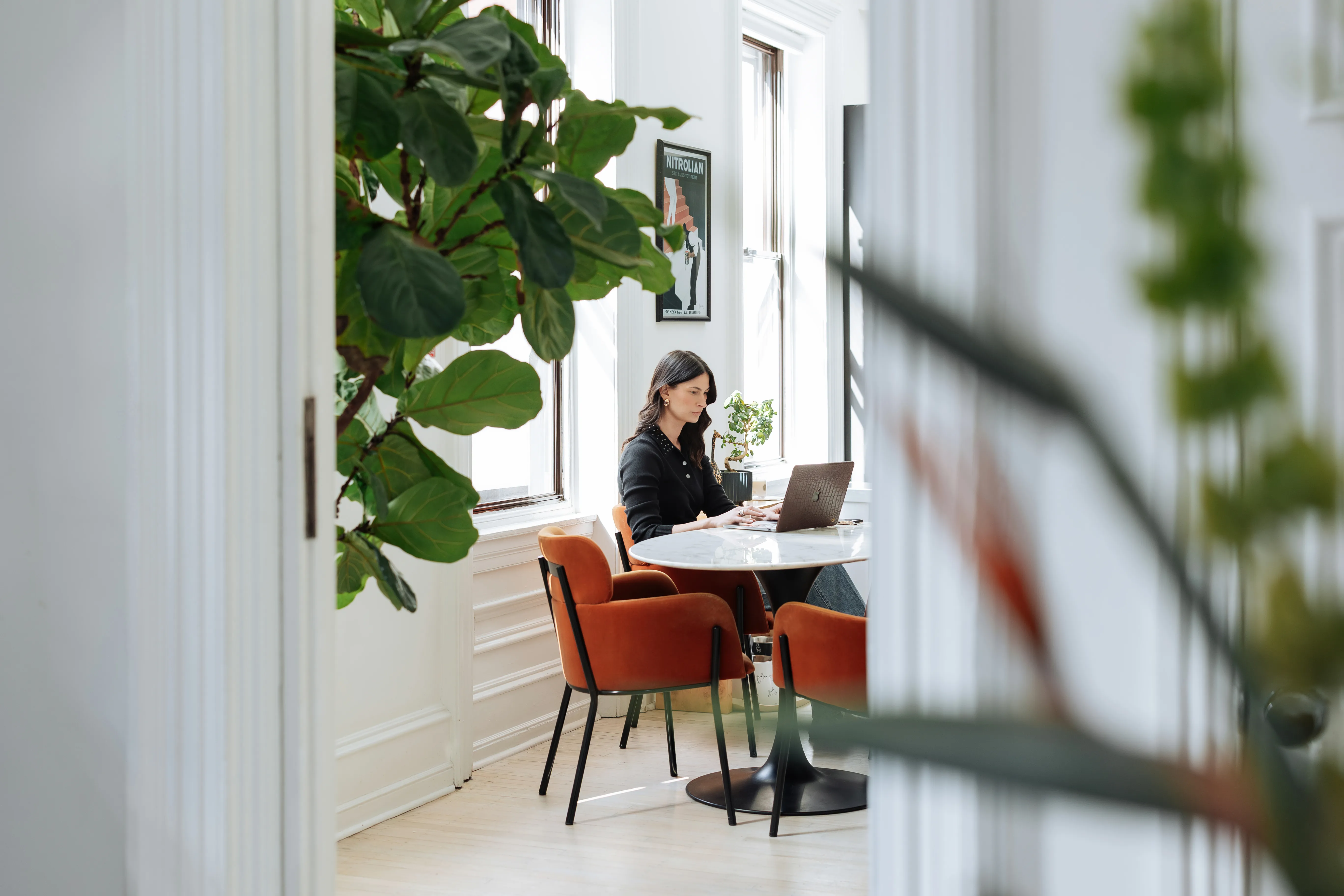 Designer working on laptop at studio preparing project proposal